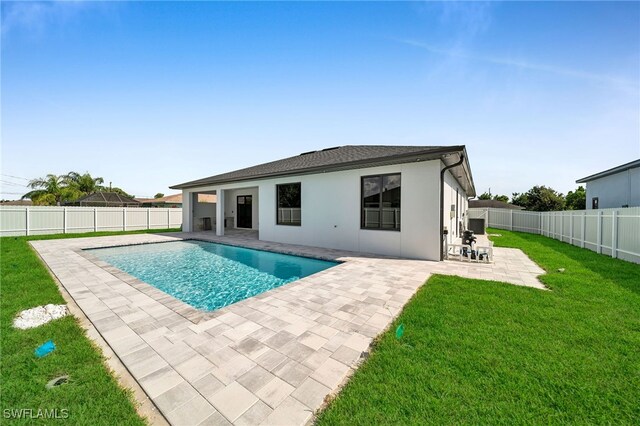 view of pool with a yard and a patio