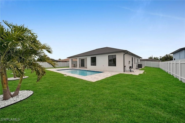 back of property featuring a patio area, a fenced backyard, a yard, and central AC unit