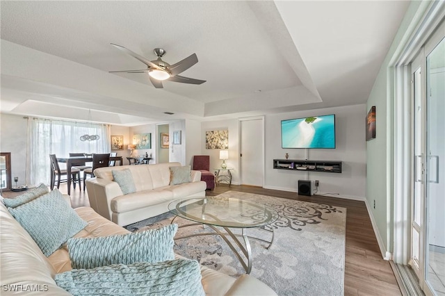 154 Penny Ln Unit 8, Naples, FL 34112 - living room featuring ceiling fan, baseboards, wood finished floors, and a raised ceiling