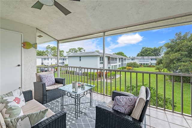 sunroom / solarium featuring ceiling fan