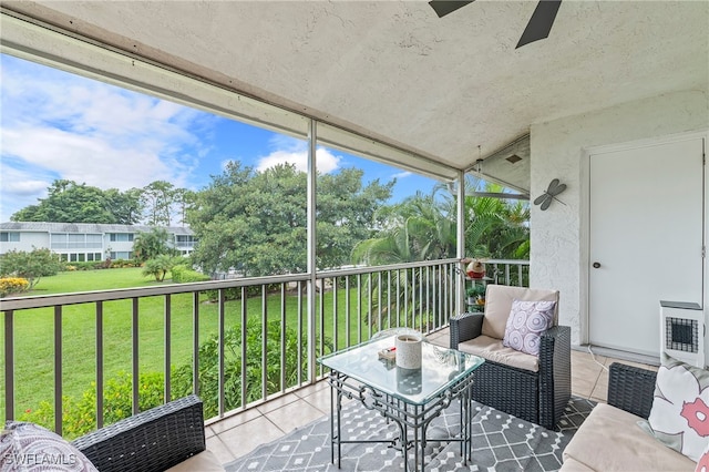 sunroom featuring ceiling fan and heating unit