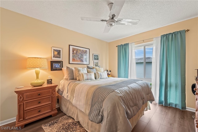 bedroom featuring ceiling fan, hardwood / wood-style flooring, and a textured ceiling