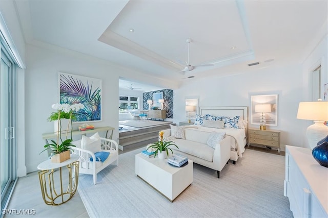 bedroom featuring a tray ceiling and visible vents