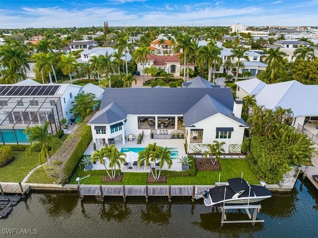 birds eye view of property with a water view and a residential view