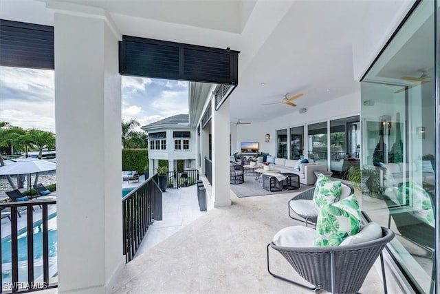 view of patio featuring a balcony and a ceiling fan