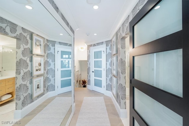 bathroom with recessed lighting, vanity, baseboards, ornamental molding, and wallpapered walls