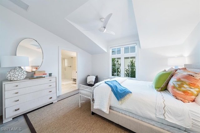 bedroom with connected bathroom, vaulted ceiling, light wood finished floors, and ceiling fan