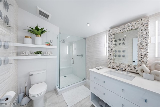 full bath featuring a stall shower, visible vents, toilet, vanity, and tile walls