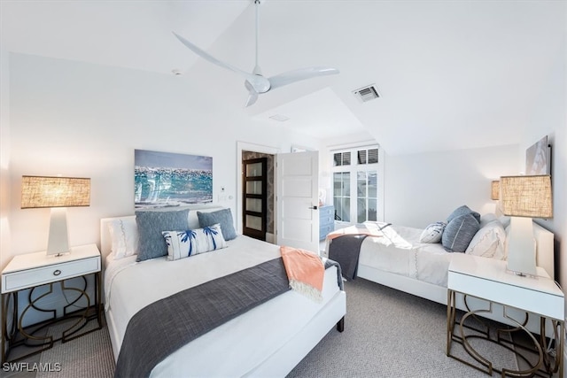 carpeted bedroom featuring lofted ceiling and visible vents