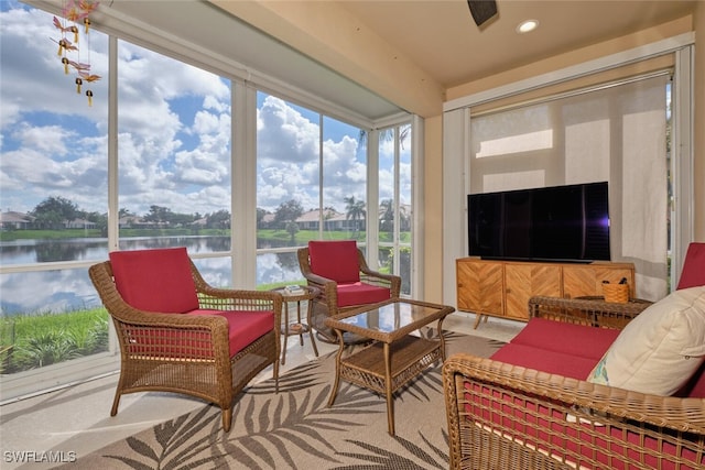 sunroom / solarium featuring a water view