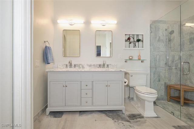 bathroom with vanity, a shower with shower door, and toilet