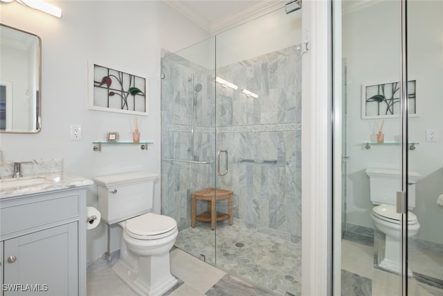 bathroom featuring vanity, a shower with shower door, toilet, and crown molding