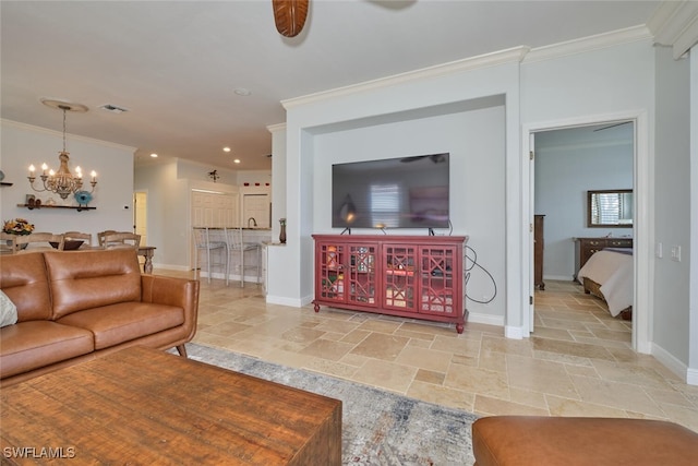 living room featuring crown molding and a chandelier