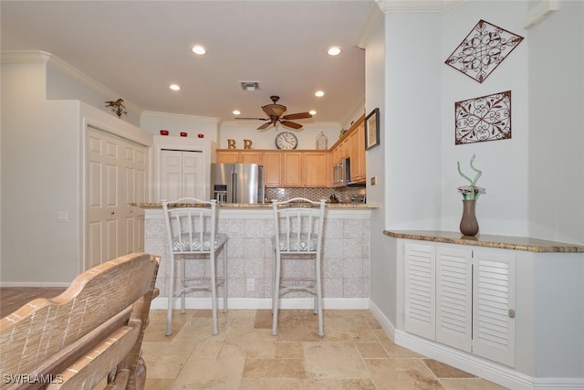 kitchen featuring appliances with stainless steel finishes, tasteful backsplash, kitchen peninsula, crown molding, and ceiling fan