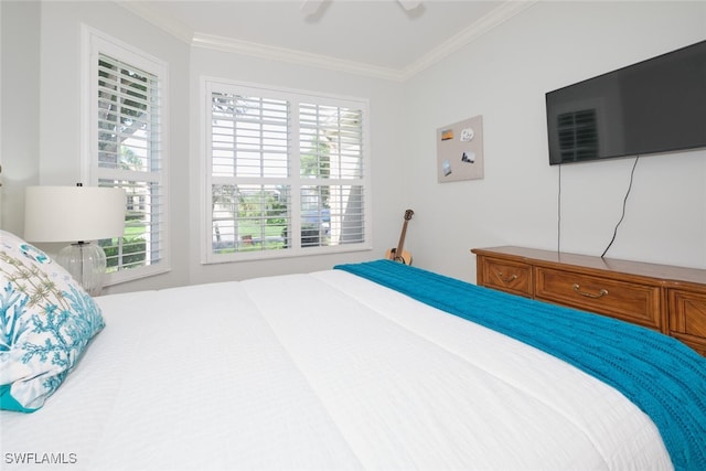 bedroom with ceiling fan, crown molding, and multiple windows