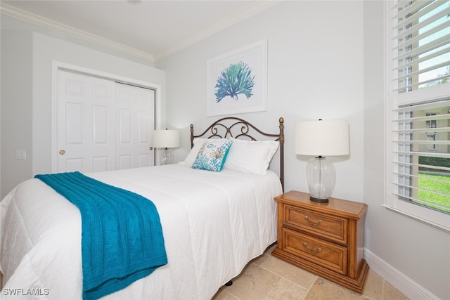 bedroom with a closet, ornamental molding, and multiple windows