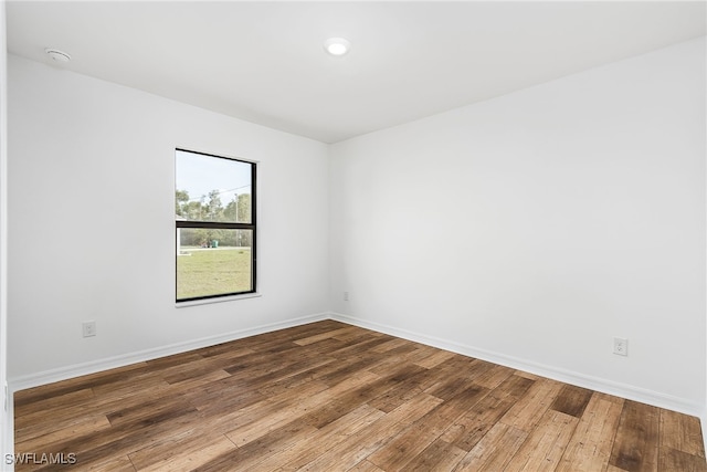 spare room with wood-type flooring