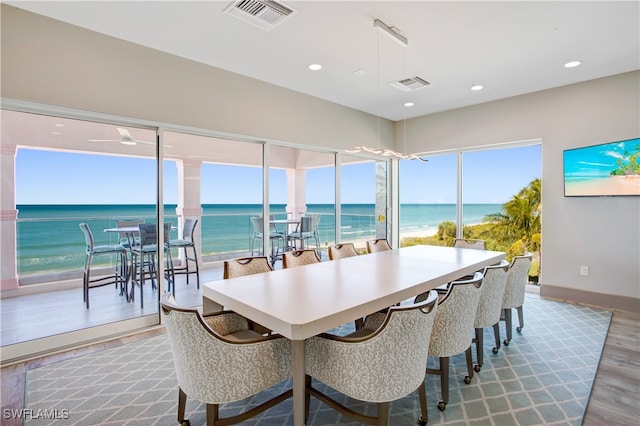 dining space featuring hardwood / wood-style floors and a beach view