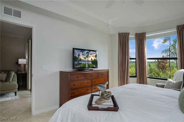 tiled bedroom with ceiling fan and ornamental molding