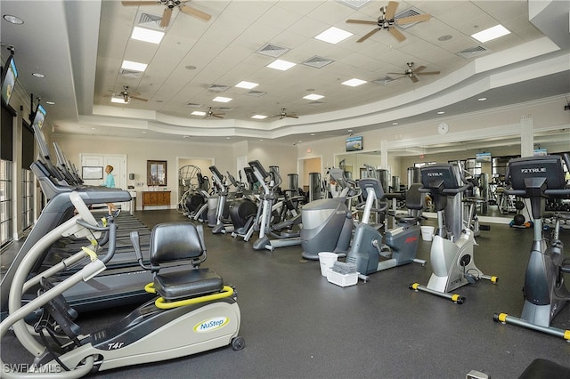 gym featuring a tray ceiling, a drop ceiling, and crown molding