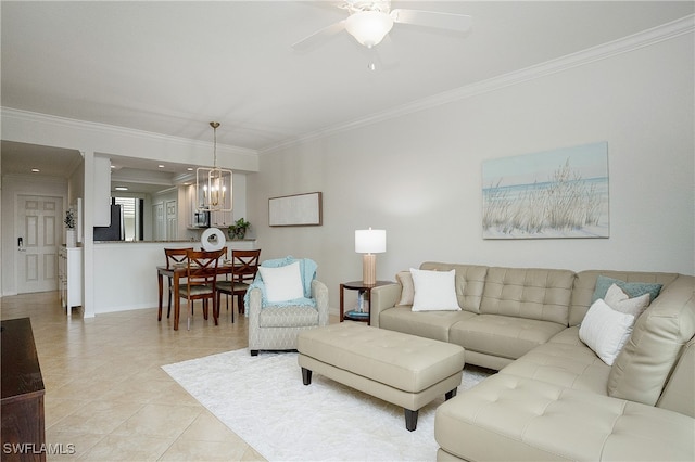 living room with ceiling fan with notable chandelier, light tile patterned floors, and crown molding