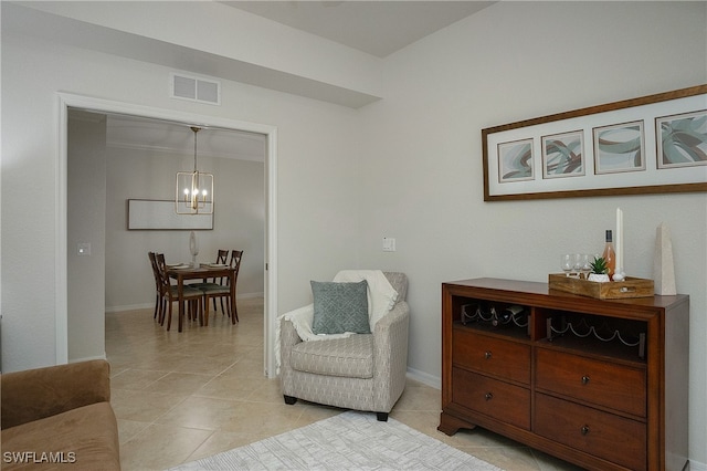 sitting room with a notable chandelier and light tile patterned flooring