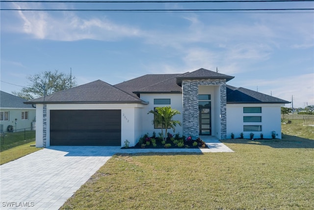 view of front of home featuring a garage and a front lawn