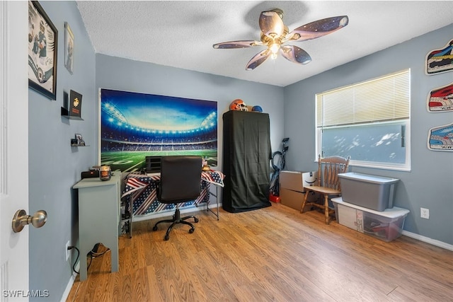 office space with wood-type flooring, a textured ceiling, and ceiling fan