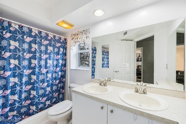 bathroom with vanity, curtained shower, and toilet