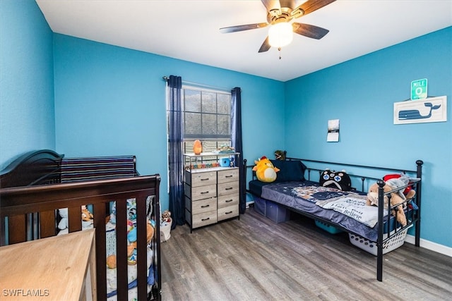 bedroom with wood-type flooring and ceiling fan