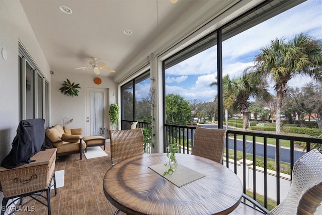 sunroom featuring ceiling fan