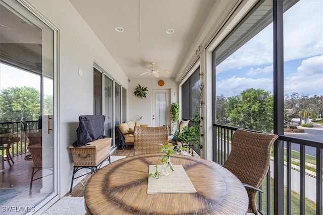 sunroom / solarium featuring ceiling fan and plenty of natural light