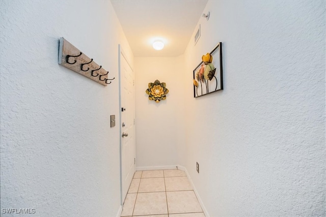 hall with light tile patterned floors