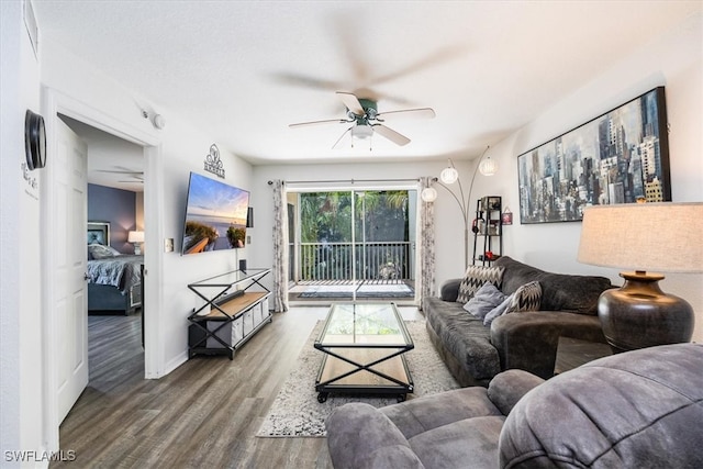 living room with ceiling fan and hardwood / wood-style flooring