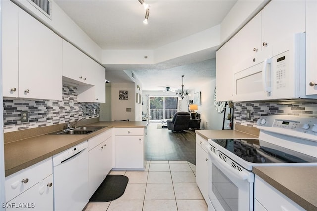 kitchen featuring white appliances, ceiling fan, white cabinetry, and sink