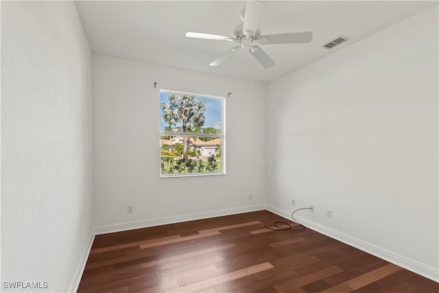 empty room with ceiling fan and dark wood-type flooring