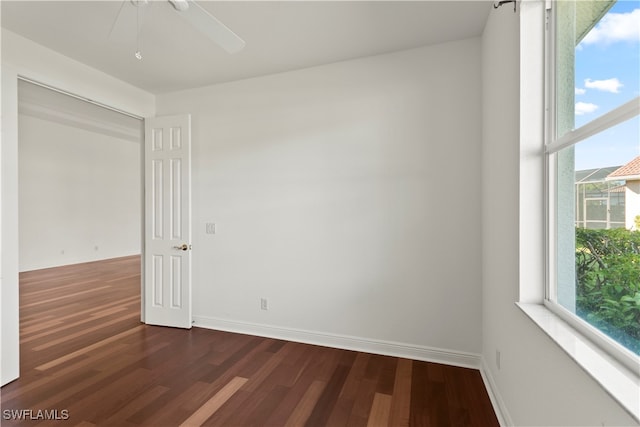 spare room featuring ceiling fan and dark hardwood / wood-style floors