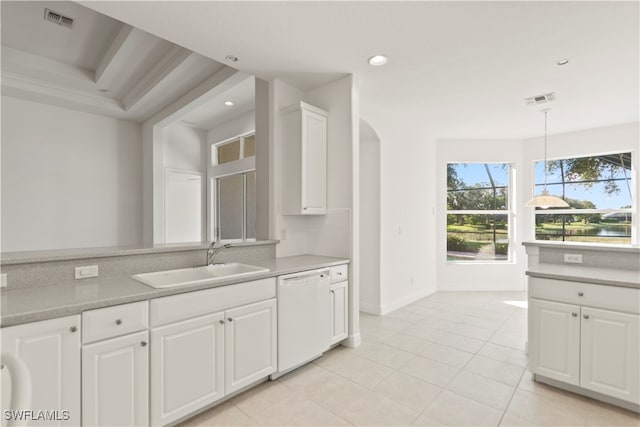 kitchen with white cabinets, pendant lighting, light tile patterned flooring, sink, and dishwasher