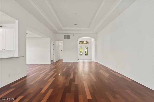 unfurnished living room featuring french doors, a raised ceiling, and dark hardwood / wood-style flooring