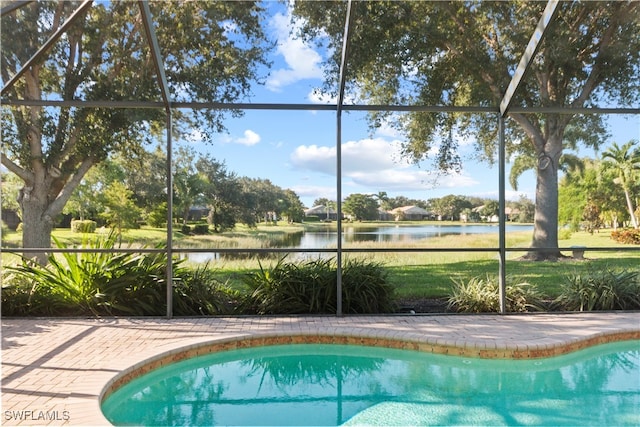 view of pool with a water view and a lanai