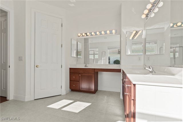 bathroom with tile patterned floors, a healthy amount of sunlight, vanity, and walk in shower