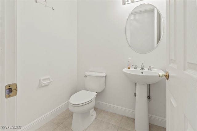 bathroom with tile patterned flooring and toilet