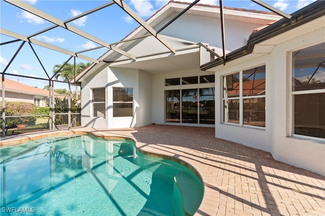 view of swimming pool with a lanai and a patio