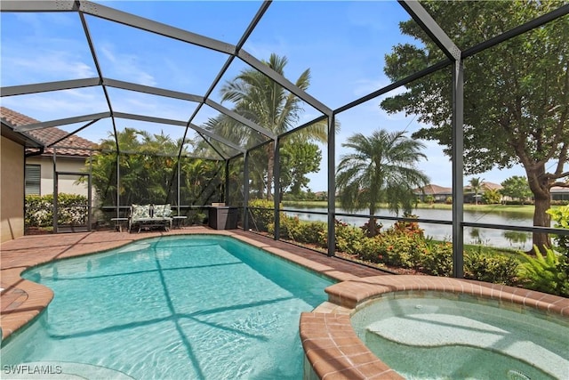 view of swimming pool with an in ground hot tub, a patio, glass enclosure, and a water view