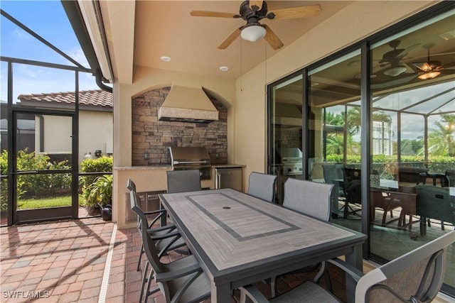 sunroom featuring ceiling fan