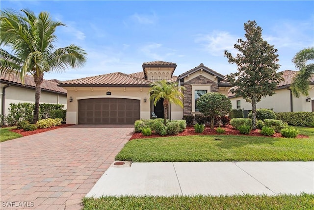 mediterranean / spanish-style home featuring a garage and a front yard