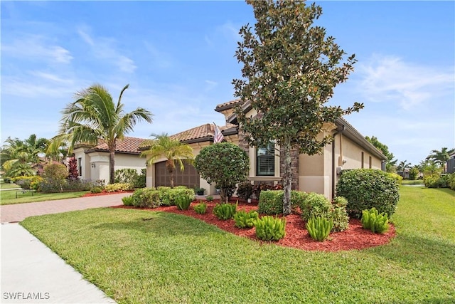 view of front of home with a garage and a front yard