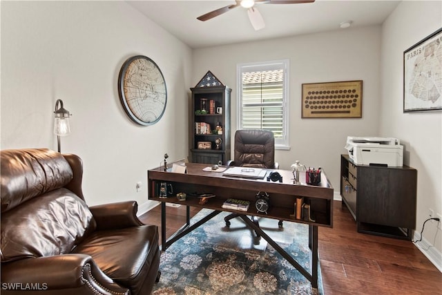 home office with dark hardwood / wood-style floors and ceiling fan