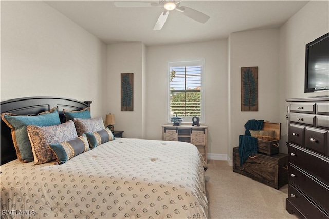 bedroom featuring light colored carpet and ceiling fan