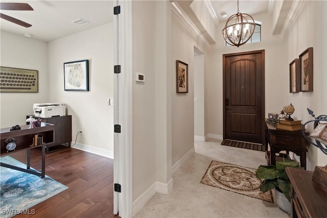 foyer entrance featuring ceiling fan with notable chandelier and light hardwood / wood-style floors